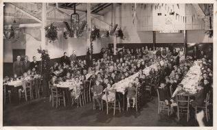 Children sit for their Christmas tea party in the Works' canteen, 1940s